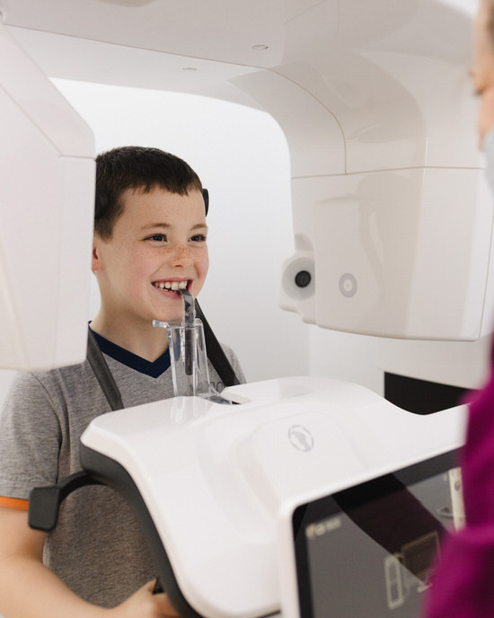 Niño durante una radiografía dental panorámica en el Centro Odontológico Miguel González, clínica dental en Oviedo